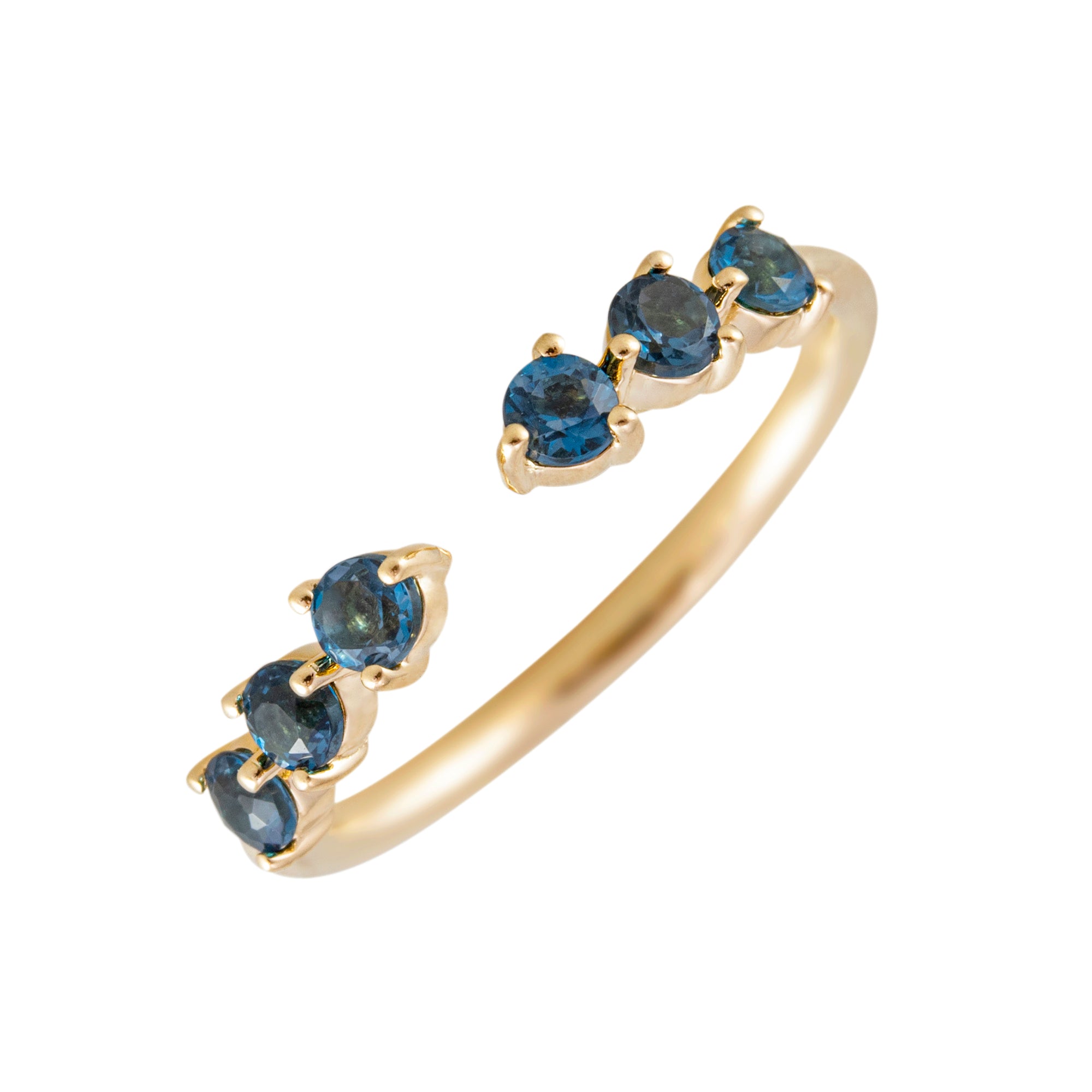 Anillo abierto en oro 18k con topacios en azul en fondo blanco