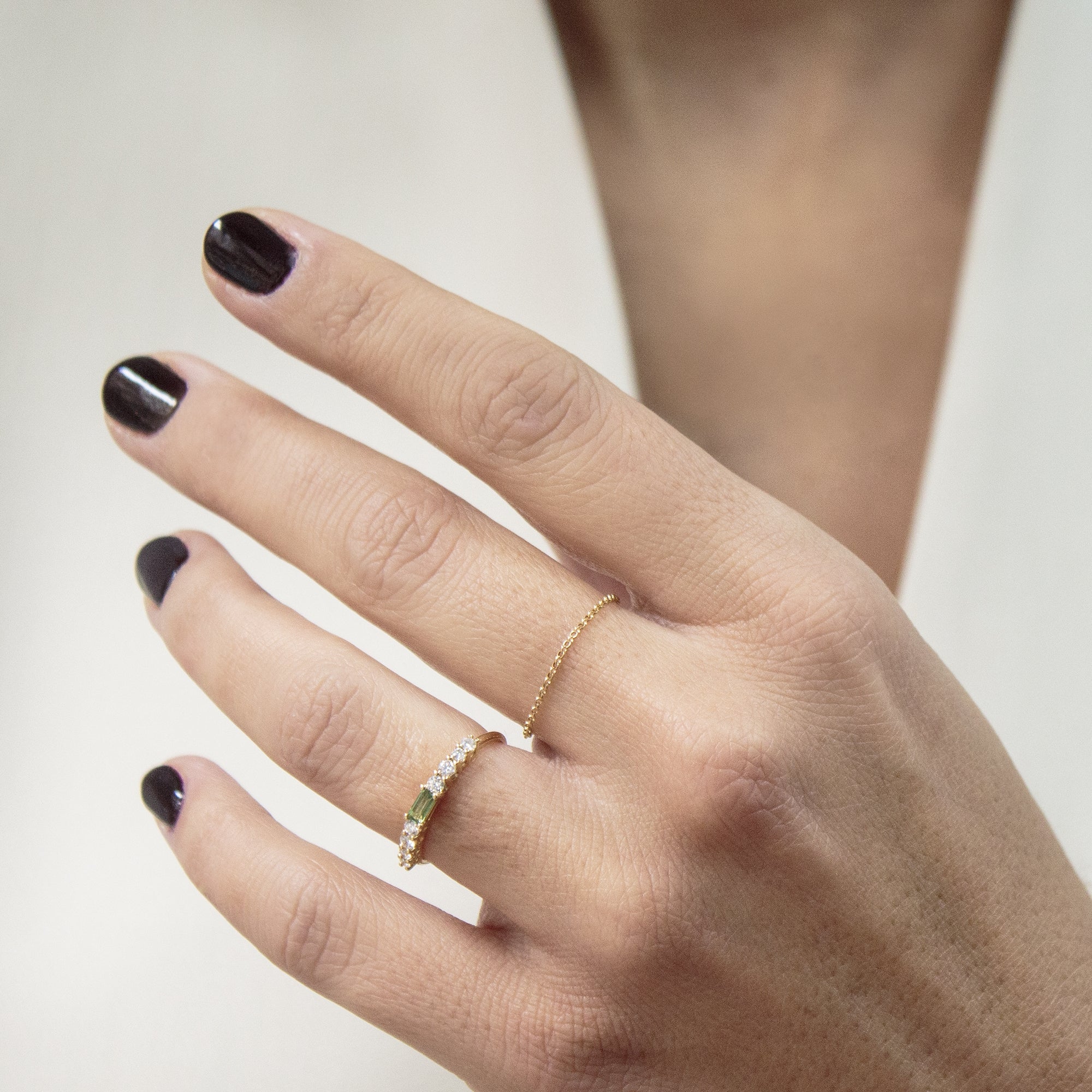 Anillo en oro 18K Turmalina verde y diamantes en el dedo de una mujer